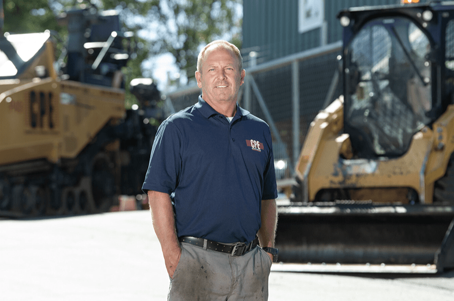 A man standing in front of some construction equipment.