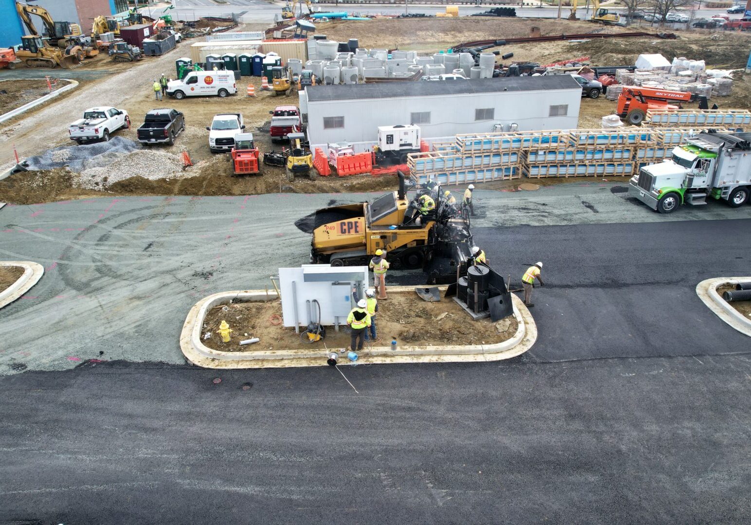 A construction site with workers and equipment on the ground.